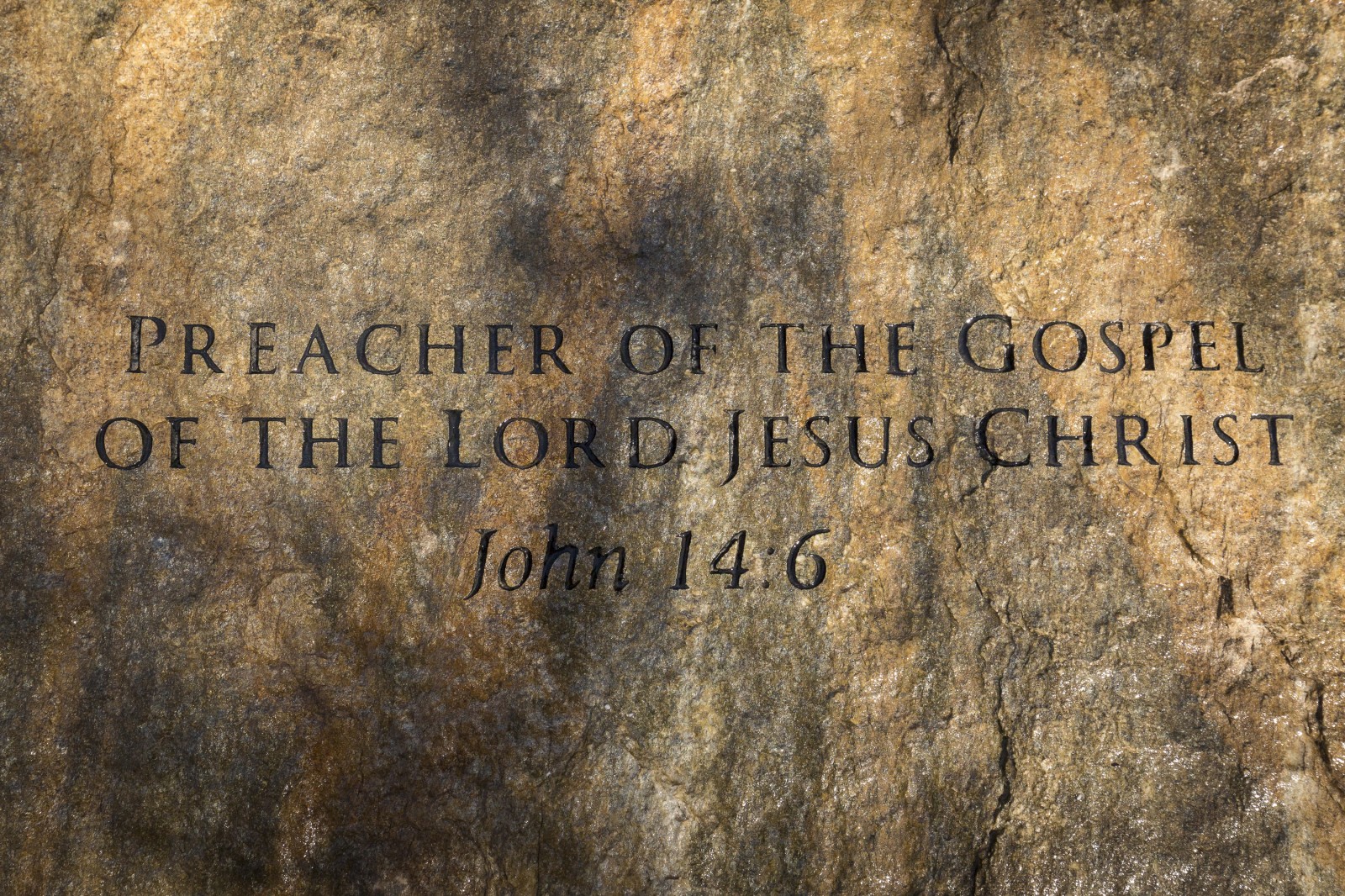 A slab of North Carolina stone marks the grave of Billy Graham, buried next to his wife, Ruth, at the Prayer Garden located next to the Billy Graham Library in Charlotte. The marker inscription bears the text, "Preacher of the Gospel of the Lord Jesus Christ" with the Scripture reference, John 14:6. (Billy Graha's Grave Marker)