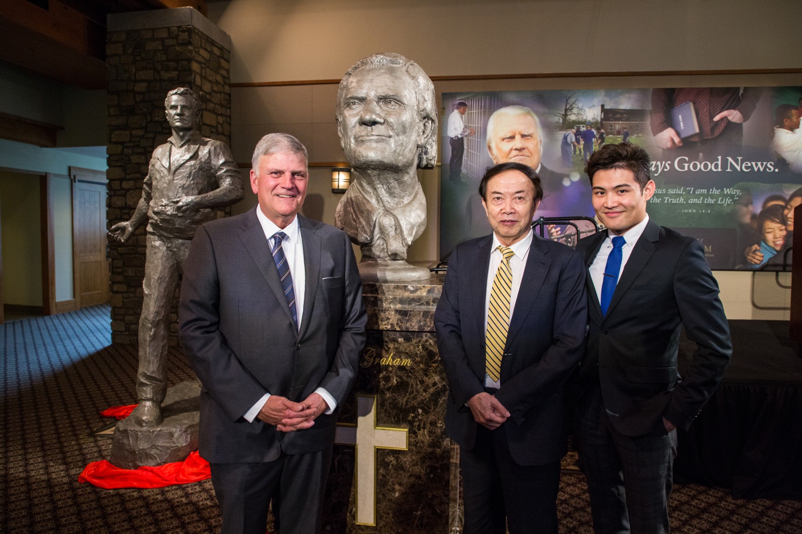 Left to right: Franklin Graham, Chinese artist Yuan Xikun and the artist's son, Henri Yuan Xikun, posed for a photo with the bust entitled, "Billy Graham as Messenger," one of two sculptures unveiled. The second is in the background to the left. 