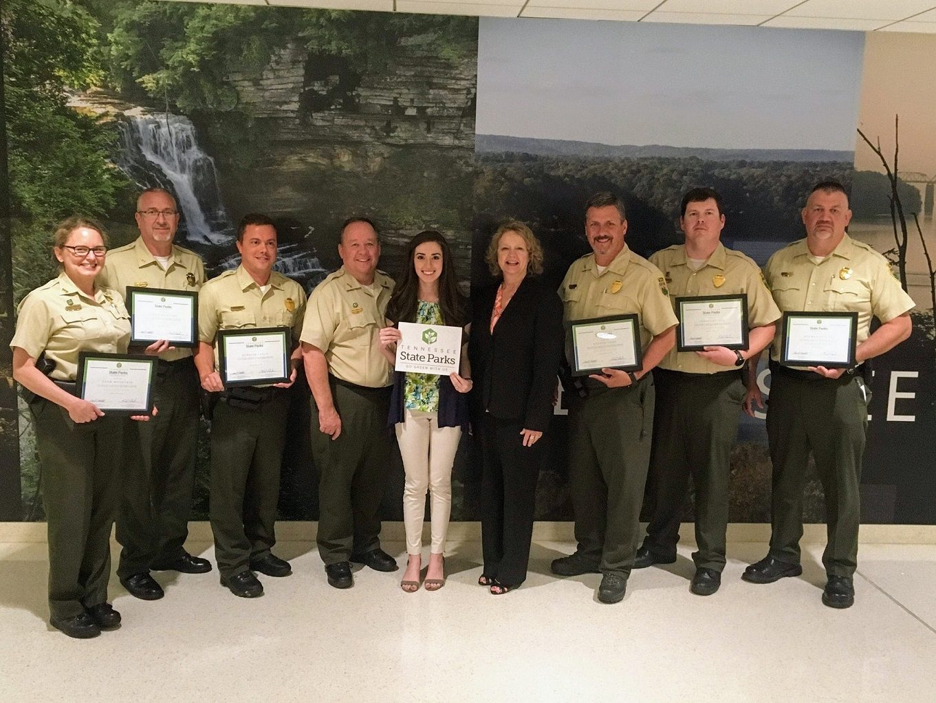 From left are Robin Peeler, area manager; Kim Moore, area manager; Kenny Gragg, area manager; Mike Robertson, parks director;  Kelsey Davis, environmental scientist for TDEC, Anne Marshall, acting deputy commissioner; Chris Padgett, area manager; Ryan  Forbess, area manager; and Mike Dobis, area manager.| The Tennessee Department of Environment and Conservation (TDEC) today recognized all 56 state parks for their efforts in environmental sustainability practices as part of the state’s Go Green With Us program.