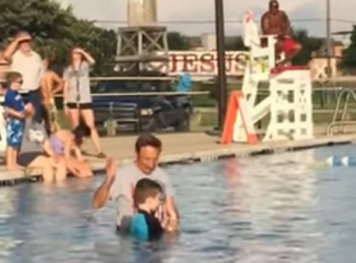 Boy Gets Baptized and a Jesus Truck Passes in background - Watch the truck in the background right before he gets baptized.