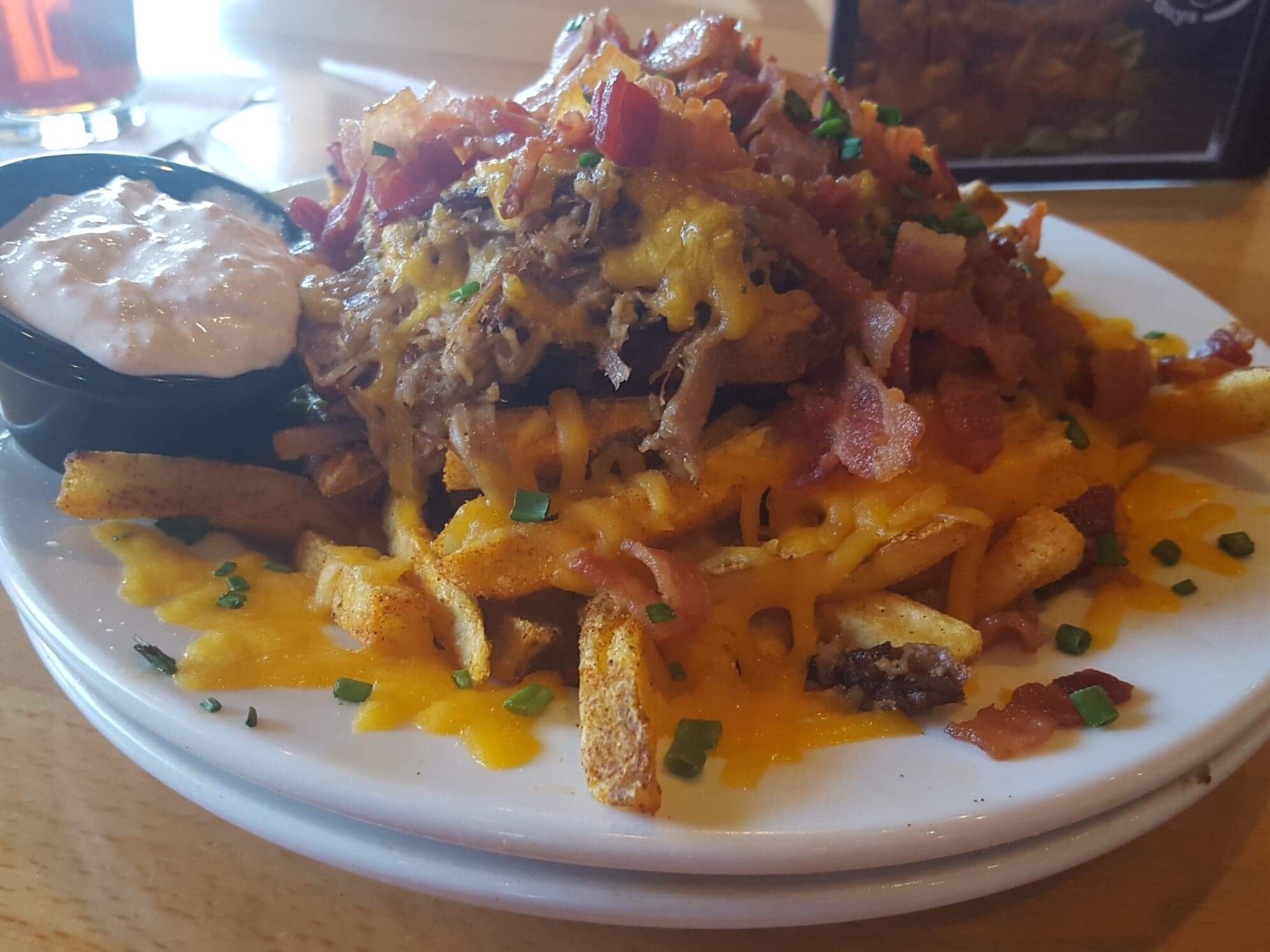 Man these pig fries, were very yummy. They are made with french fries, their base dry rub seasoning. Then it is topped with cheese, pulled pork and bacon. I have to say that is the best fry mix appetizer that I have ever had!  #BKW Big Kahuna Wings 