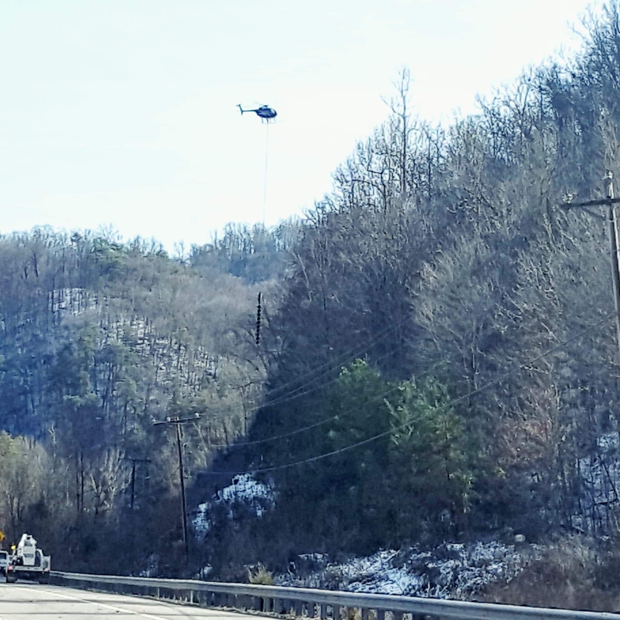 Outside my window I cannot believe … A helicopter cutting down trees along Highway 25E between Harrogate, TN and Jefferson City, TN.