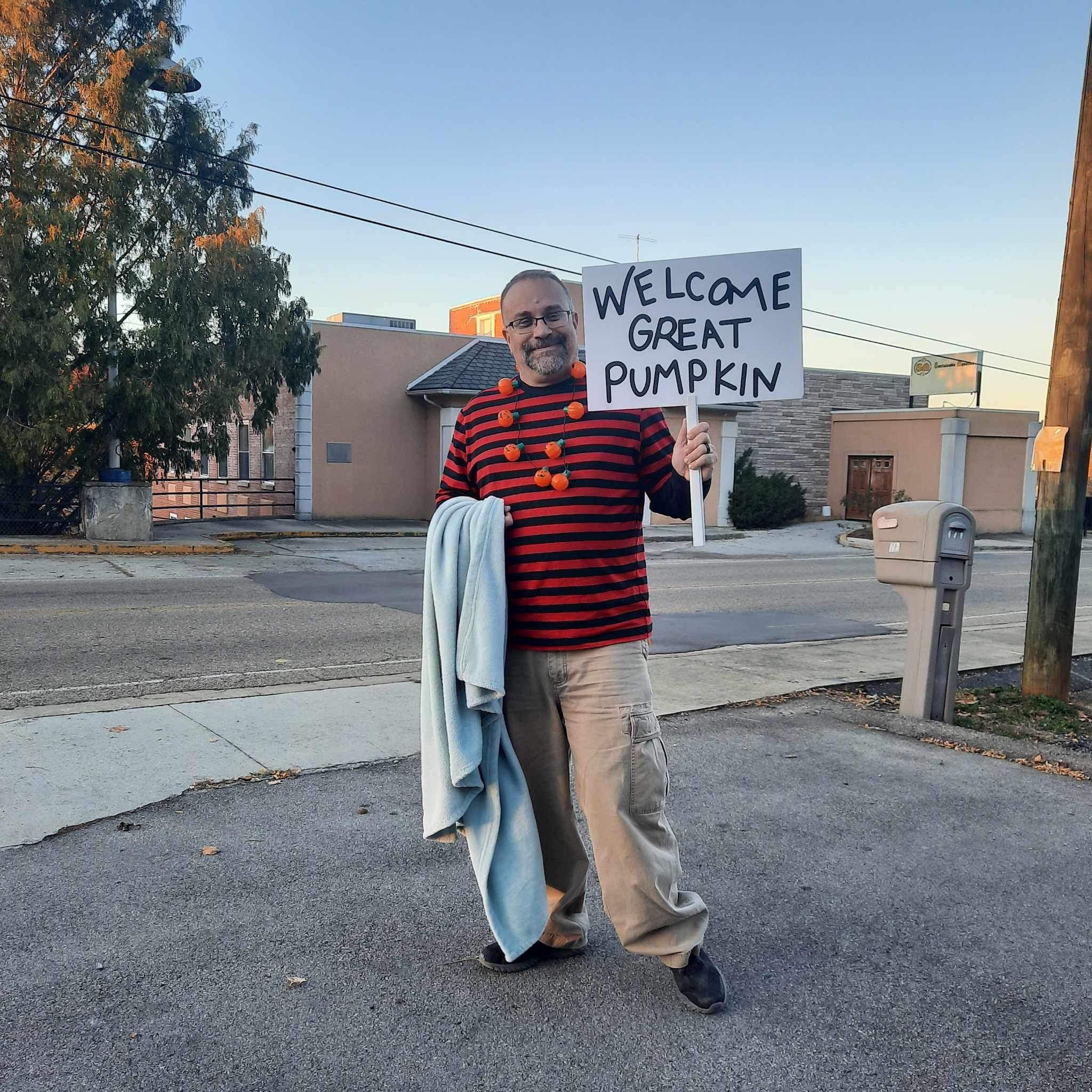 I had fun doing this, we set up at a local small business near us. I waved at drivers passing by and holding my Welcome Great Pumpkin sign. We did have a good turnout with only a few cars set up. But they did have things inside for the family.  (Linus of The Great Pumpkin) 