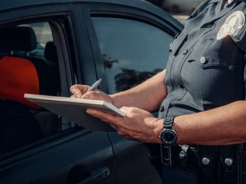 Police Officer Writing on a Notebook