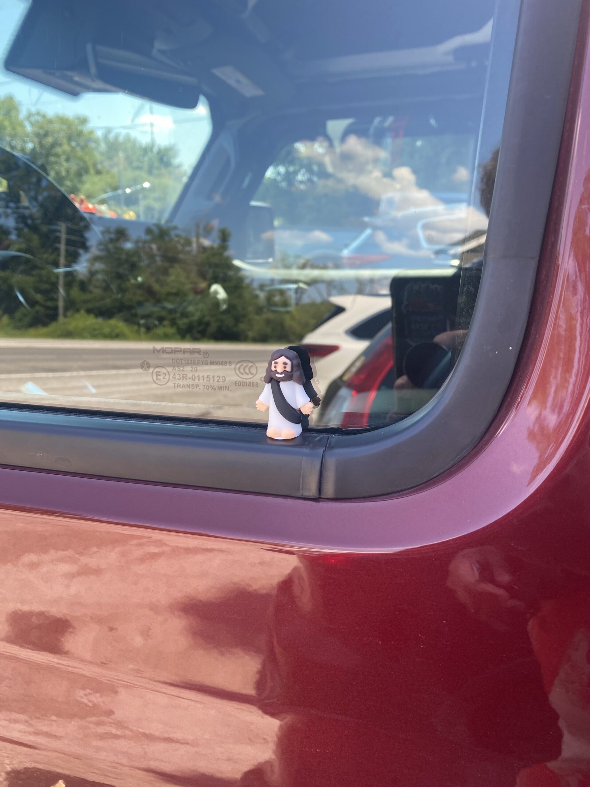 Place Little Jesus on a car. He sit perfectly on the window of this Jeep. 