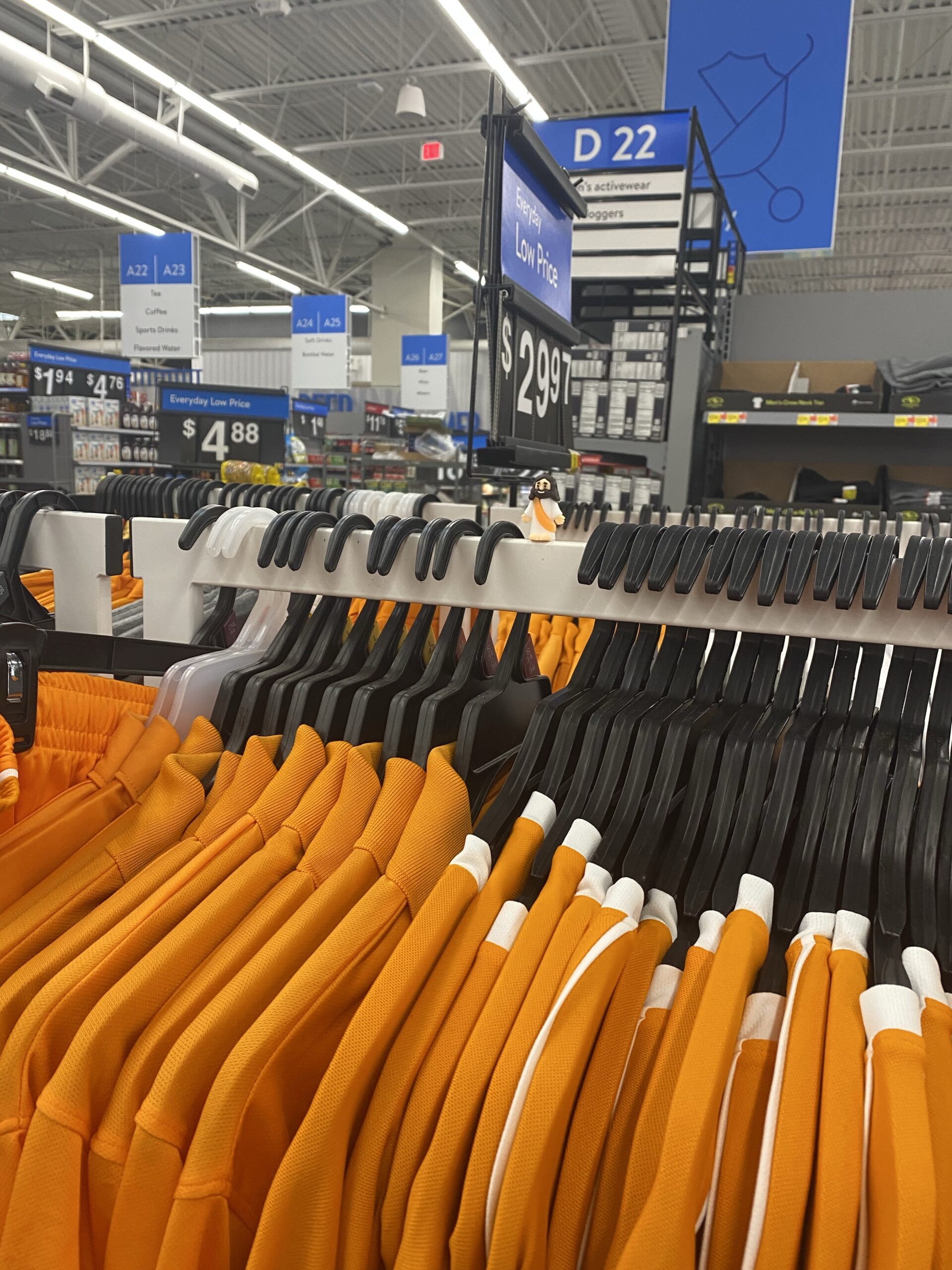 Color coordinated the Little Jesus with these orange shirts on a clothing rack. 